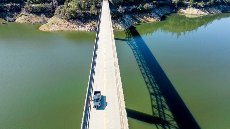 A car crosses Enterprise Bridge over Lake Oroville on March 26, 2023, in Butte County, California