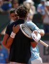 Novak Djokovic of Serbia (L) hugs Ernests Gulbis of Latvia after winning their men's semi-final match during the French Open tennis tournament at the Roland Garros stadium in Paris June 6, 2014. REUTERS/Gonzalo Fuentes (FRANCE - Tags: SPORT TENNIS)