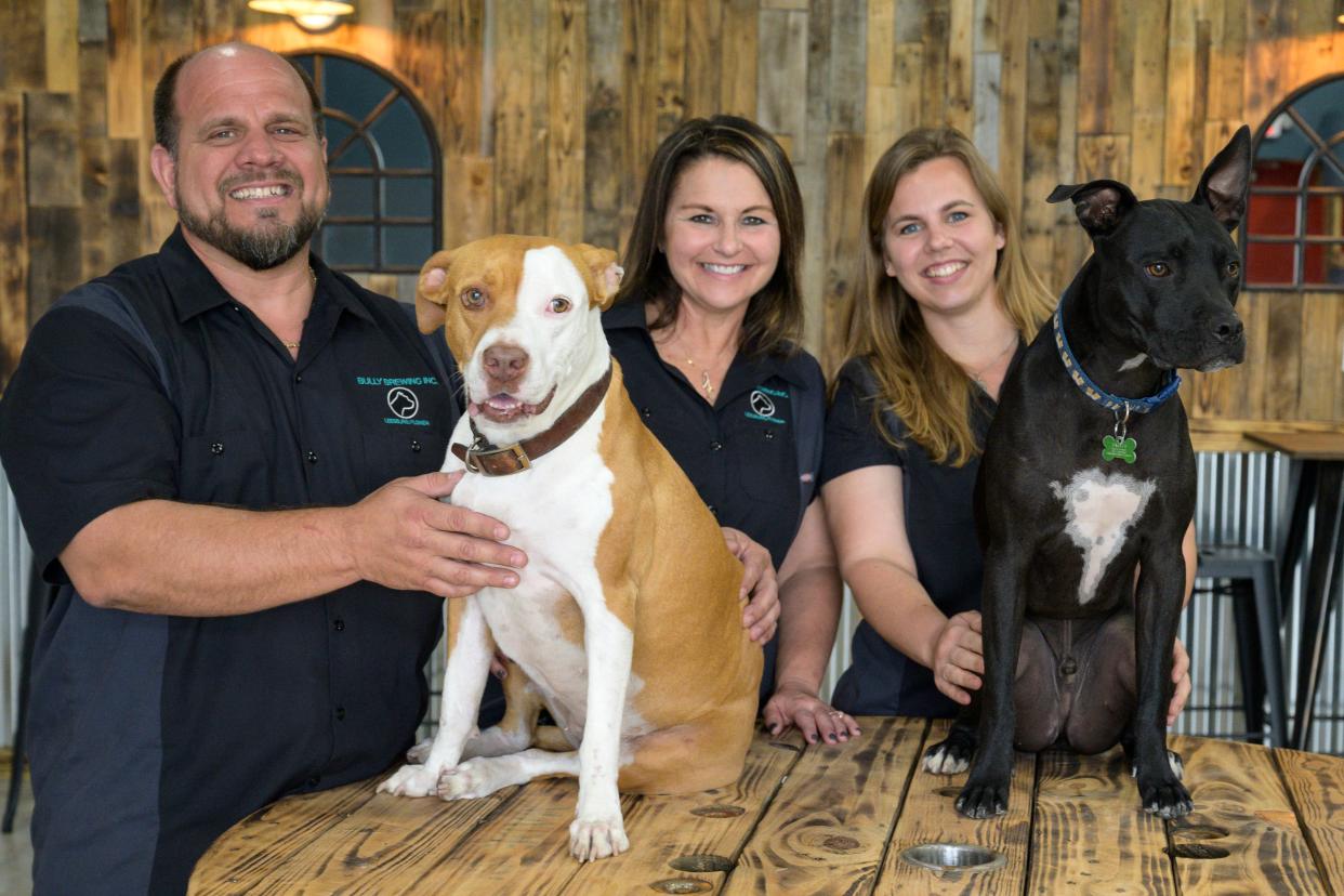 Dogs from the Humane Society of Lake County will tug your heart strings at the Adoption Day at Bully Brewing Inc. Here, co-owners Ryan Gonzalez and Shannon Kent, with Head brewer Falisha Gonzalez, show off their puppy mascots - Dixie and Barley - at Bully Brewing in Leesburg.