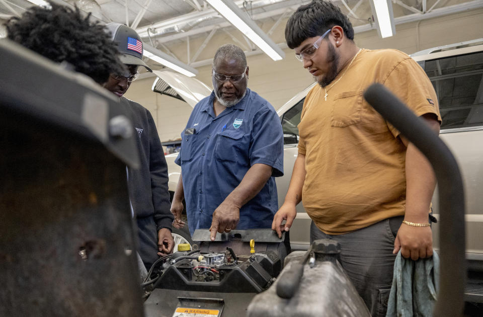 Lead Mechanic Instructor Albert Williams helps Carlos Flores with a piece of equipment that will not start during The Hendry County Adult Learning Automative Skills Lab on Thursday, March 14 ,2024. The program helps adults gain the necessary experience to receive certification and immediately enter the local workforce after completion in Clewiston, Fla. (AP Photo/Chris Tilley)