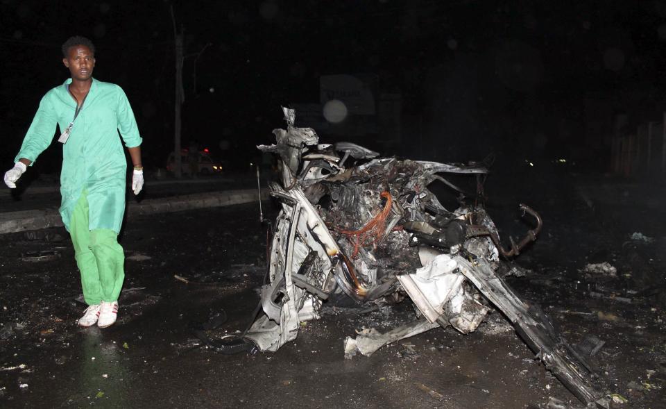 A firefighter walks at the scene of an explosion outside the Jazira hotel in Mogadishu, January 1, 2014. Three bombs exploded within an hour outside the hotel in a heavily fortified district of the Somali capital on Wednesday, killing at least 11 people. (REUTERS/Feisal Omar)