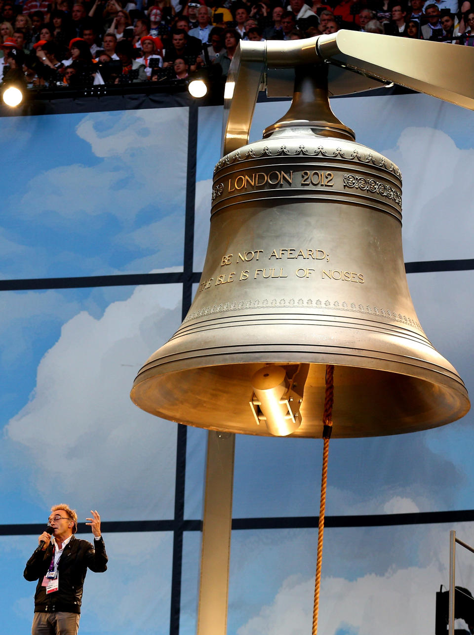 LONDON, ENGLAND - JULY 27: Artistic Director of the Opening Ceremony Danny Boyle speaks whilst standing next to the Olympic Bell during the Opening Ceremony of the London 2012 Olympic Games at the Olympic Stadium on July 27, 2012 in London, England. (Photo by Cameron Spencer/Getty Images)