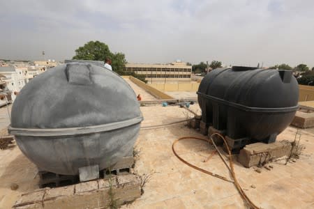 Water tanks are seen during a water shortage in Tripoli