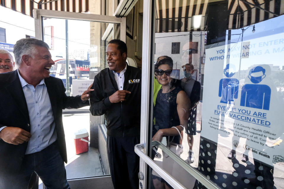 Republican conservative radio show host Larry Elder, second from left, and former Lt. Gov. Abel Maldonado, left, leave after they visiting Philippe The Original Deli during a campaign for the California gubernatorial recall election on Monday, Sept. 13, 2021, in Los Angeles. (AP Photo/Ringo H.W. Chiu)