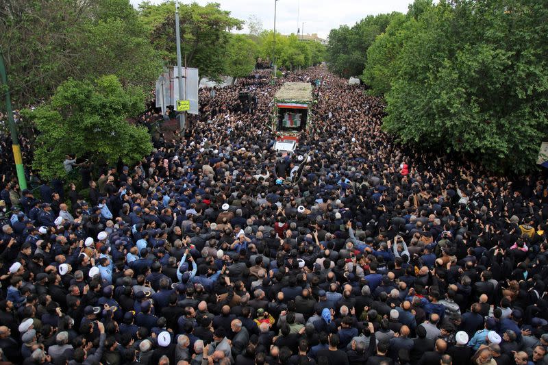 People attend a funeral ceremony for the late Iranian President Ebrahim Raisi in Tabriz