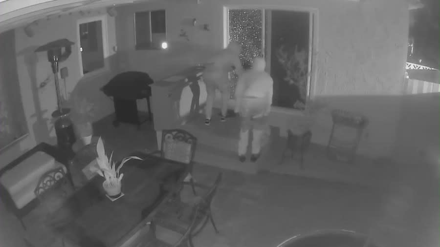 Two suspects peering into the window of a Westchester home in Los Angeles County amid a series of violent break-ins.