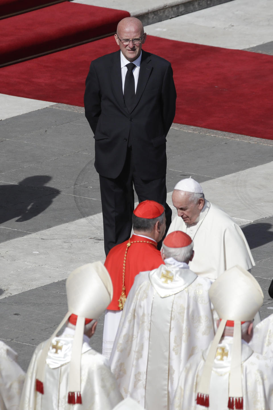 Vatican head of security Domenico Giani, top, looks at Pope Francis at the end of a canonization Mass in St. Peter's Square at the Vatican, Sunday, Oct. 13, 2019. The Vatican said Monday Oct. 14, 2019 that Francis’ chief bodyguard Giani has resigned over the leak of a Vatican police flyer identifying five Holy See employees who were suspended as part of a financial investigation, adding that Giani bore no responsibility for the leak, but that he had resigned to ensure the serenity of the investigation and “out of love for the church and faithfulness” to the pope. (AP Photo/Alessandra Tarantino)