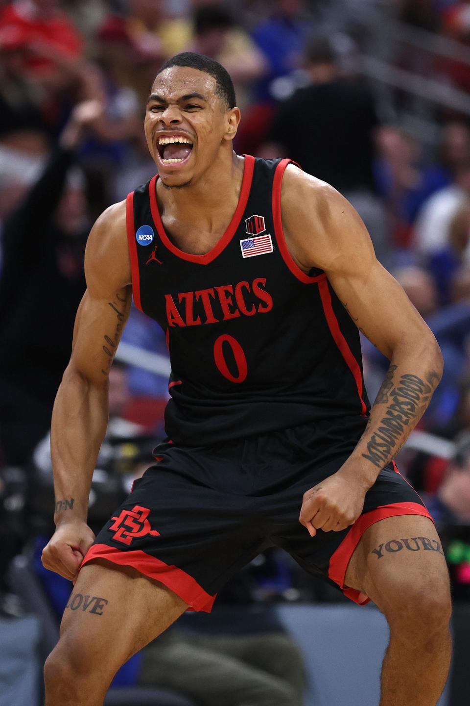 March 24, 2023: Keshad Johnson #0 of the San Diego State Aztecs celebrates after defeating Alabama Crimson Tide, 71-64, during the second half in the Sweet 16 round of the NCAA Men's Basketball Tournament at KFC YUM! Center in Louisville, Kentucky.
