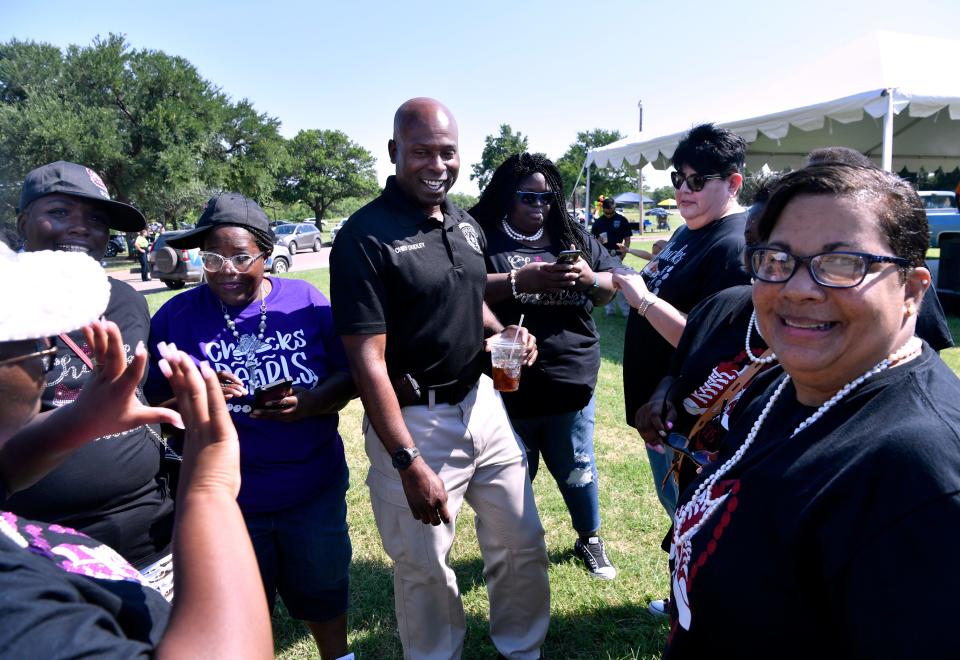 Abilene Police Chief Marcus Dudley is surrounded by members of the "Chucks and Pearls 325" group after the 2021 Juneteenth parade in Stevenson Park.