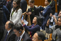 Chinese-born Australian journalist Cheng Lei, center, films a signing ceremony with Chinese Premier Li Qiang and Australian Prime Minister Anthony Albanese at Parliament House in Canberra, Monday, June 17, 2024. Li says he has agreed with Australian Prime Minister Anthony Albanese to properly manage their nations' differences as they emerge from a hostile era in which minister-to-minister contacts were banned and trade barriers cost Australian exporters up to $13 billion a year. (Lukas Coch/Pool Photo via AP)