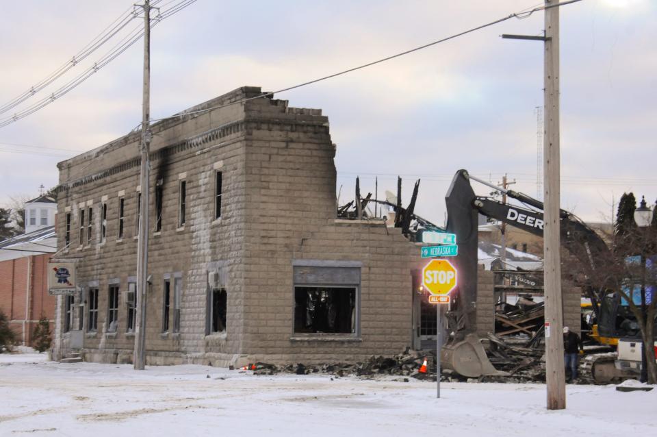 Crews take down a wall of the 117-year-old building that housed Butch's Bar and 20 apartments in downtown Sturgeon Bay on Feb. 24 after it was destroyed by fire two days before.