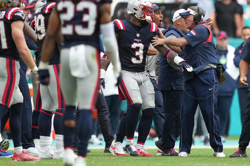 New England Patriots head coach Bill Belichick pulls his players back after an altercation breaks out during the second half of an NFL game against the Miami Dolphins at Hard Rock Stadium in Miami Gardens, Oct. 29, 2023.