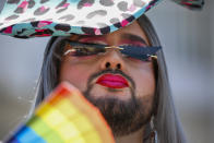 A participant pauses in the annual Pride Parade, in Tel Aviv, Israel, Friday, June 25, 2021. Thousands of people attended the parade Friday in one of the largest public gatherings held in Israel since the onset of the coronavirus pandemic. (AP Photo/Ariel Schalit)