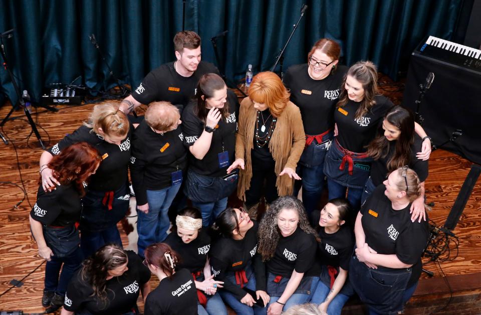 Reba McEntire talks with staff Thursday during the grand opening of Reba's Place in Atoka.