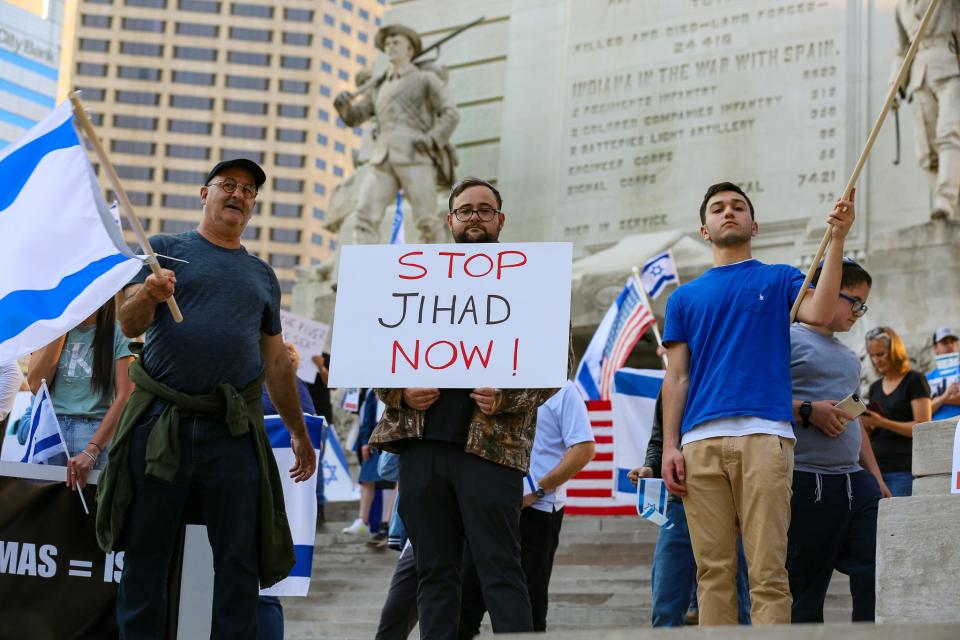Max Profeta, center, held up a "Stop Jihad Now" sign at a pro-Israel demonstration across the street from a pro-Palestinian rally on Thursday in downtown Indianapolis.