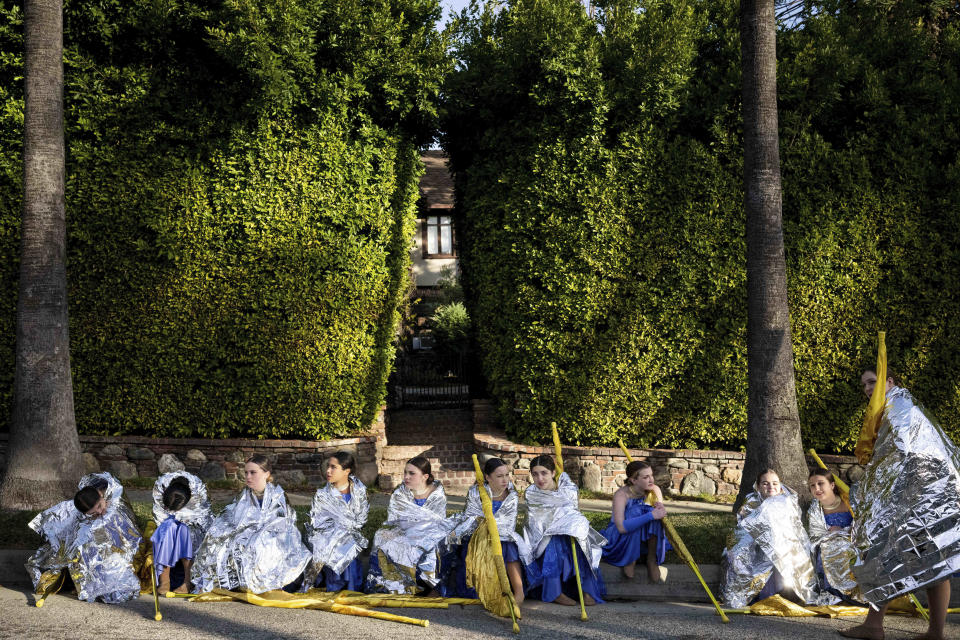 Rockford High School Marching Band's color guard attempts to stay warm as they wait for the 134th Rose Parade to begin in Pasadena, Calif., Monday, Jan. 2, 2023. (Sarah Reingewirtz/The Orange County Register via AP)
