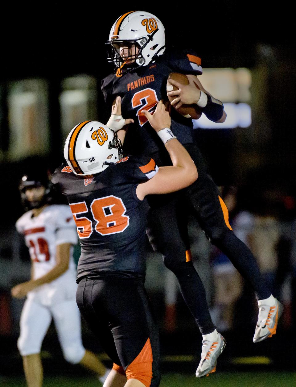 Washington's Jacob Gauf (58) lifts up teammate Evan Deasey after Deasey's touchdown against Metamora in the second half of their Week 3 football game Friday, Sept. 13, 2024 at Babcook Field in Washington. The Panthers defeated the Redbirds 37-7.