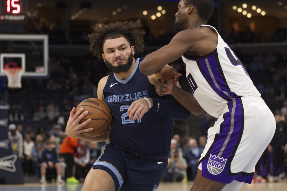 Memphis Grizzlies forward David Roddy (21) drives into the lane defended by Sacramento Kings forward Harrison Barnes, right, in the first half of an NBA basketball game Monday, Jan. 29, 2024, in Memphis, Tenn. (AP Photo/Nikki Boertman)