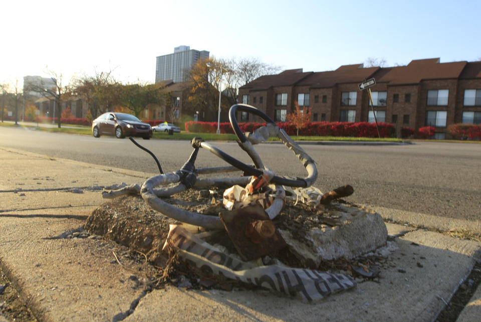 This Oct. 24, 2012, photo shows a broken streetlight base on a sidewalk east of downtown Detroit. When baseball's World Series returns to Detroit this weekend for Game 3, television viewers will see vibrant crowds and skyline shots of the city. Yet beyond the hot dogs and home runs, Detroit is struggling to cross home plate. (AP Photo/Carlos Osorio)