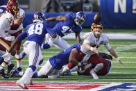 Washington Football Team quarterback Kyle Allen (8) loses control of the ball during the second half of an NFL football game against the New York Giants, Sunday, Oct. 18, 2020, in East Rutherford, N.J. Giants linebacker Tae Crowder (48) recovered the ball and scored a touchdown on the play. (AP Photo/John Minchillo)