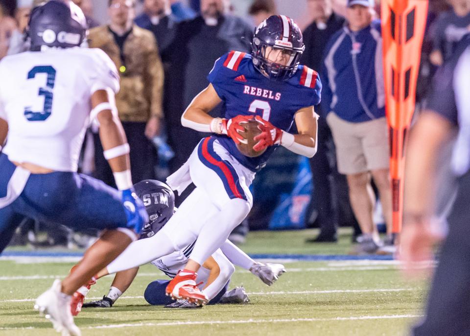 Cade Robin runs the ball as the Teurlings Rebels take on the STM Cougars. Friday, Oct. 21, 2022.