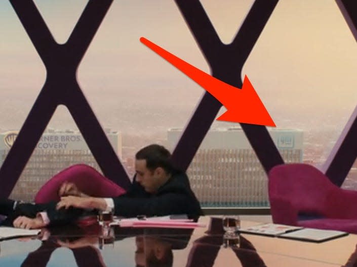 a gm office buiding is seen in the background of the mattel conference room in barbie with a red arrow pointing to it