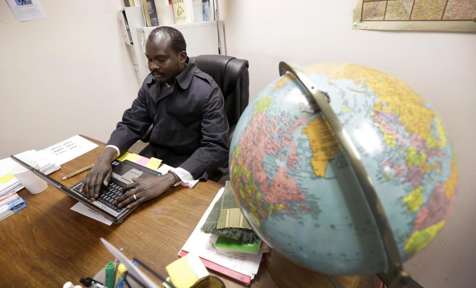 Sudanese refugee Suliman Bandas, who teaches English as second language, works in his classroom in Lincoln, Neb., on Wednesday, Jan. 4, 2017. Bandas says he hopes President-elect Donald Trump won't change the United State's role as a beacon for refugees across the world. “It should not be up to a president to change a country’s value and principle,” he says. (AP Photo/Charlie Neibergall)