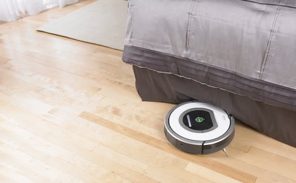 Roomba cleaning a bedroom.