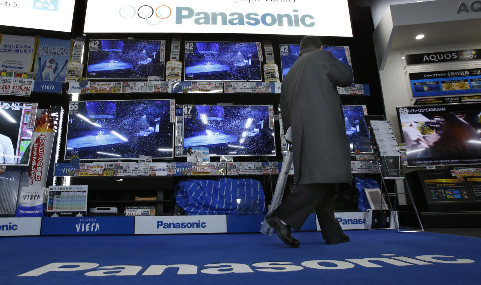 A shopper looks at Panasonic's flat-panel televisions at an electronics retail store in Tokyo Tuesday, Feb. 4, 2014. Panasonic Corp. says profit rose 20 percent in the October-December quarter as growth in businesses such as smart home systems offset its long struggling TV and appliance divisions. The Japanese manufacturing giant reported net income of 73.7 billion yen ($728 million), up from 61.3 billion yen a year earlier. (AP Photo/Shizuo Kambayashi)