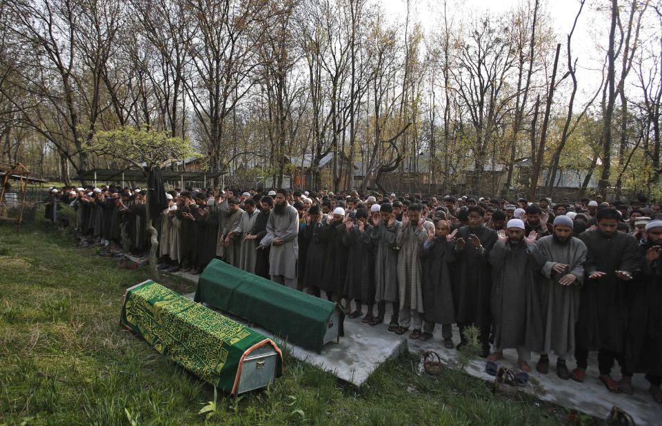 Kashmiri villagers pray by the bodies of Ghulam Nabi, a rural body head of a pro-Indian party and his son Firdous Ahmad during a joint funeral at Batgund village, some 40 kilometers (25 miles) south of Srinagar, India, Tuesday, April 22, 2013. Police say suspected rebels have killed three men in Indian Kashmir ahead of voting in general elections this week. More than a dozen rebel groups have been fighting for Kashmir's independence from India or merger with Pakistan since 1989. (AP Photo/Mukhtar Khan)