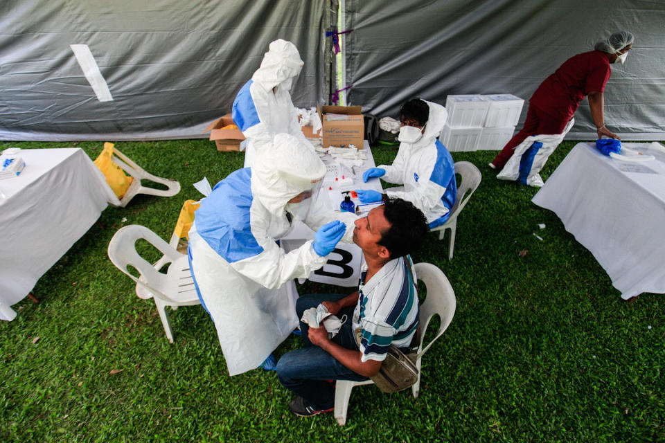 A foreign worker undergoes a swab test during a Covid-19 screening exercise at Padang Polo, George Town May 14, 2020. — Picture by Sayuti Zainudin