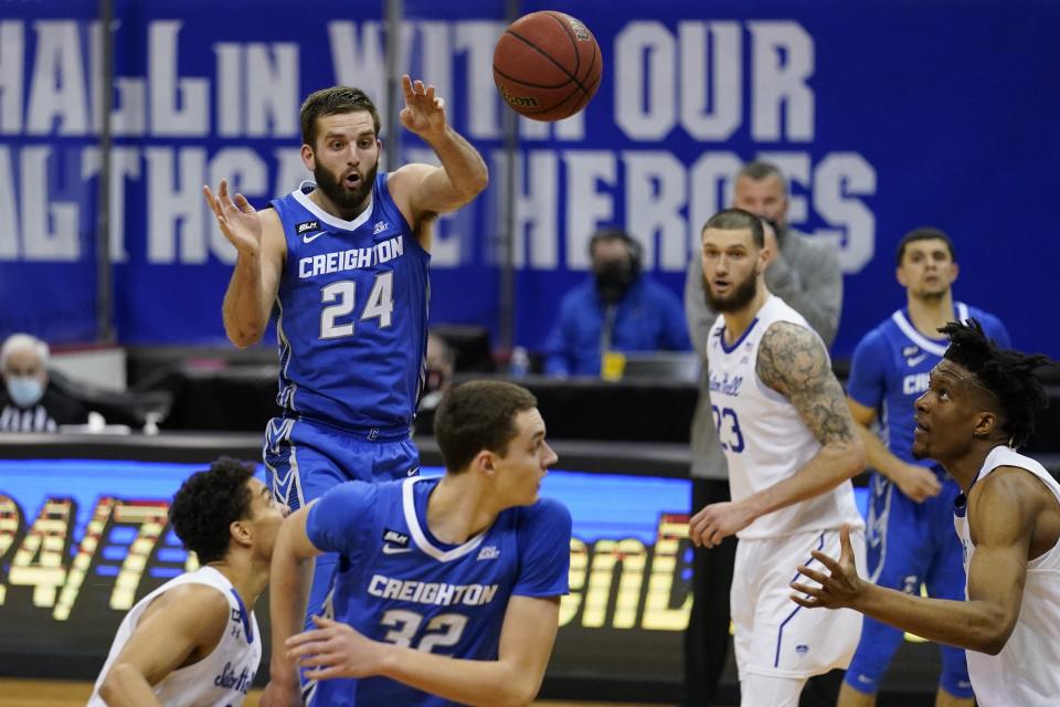 Creighton's Mitch Ballock (24) passes to Ryan Kalkbrenner (32) during the second half of an NCAA college basketball game against the Seton Hall Wednesday, Jan. 27, 2021, in Newark, N.J. Creighton won 85-81. (AP Photo/Frank Franklin II)
