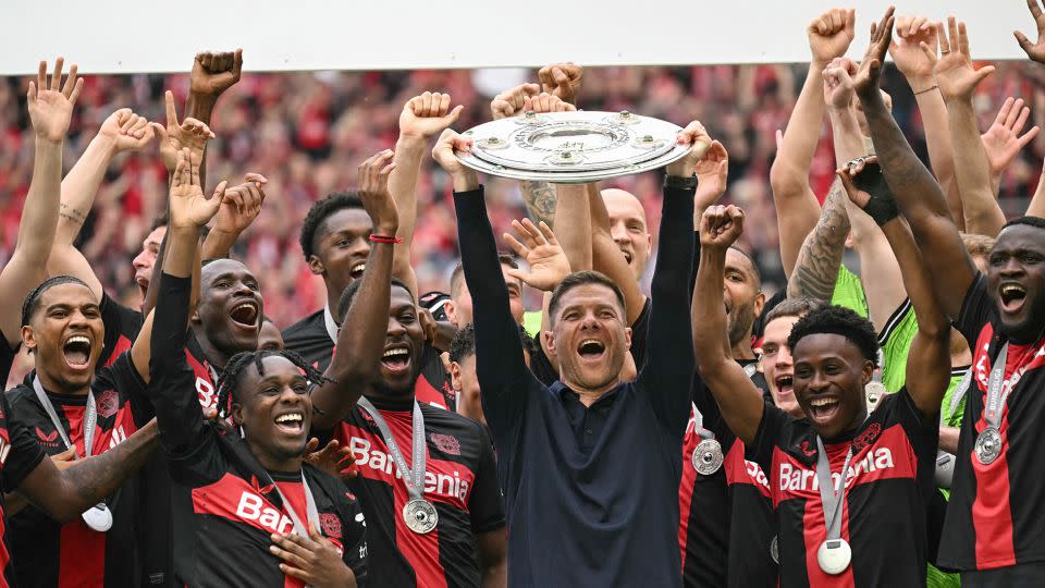 Alonso and his players celebrate with the Bundesliga trophy. - Ina Fassbender/AFP/Getty Images