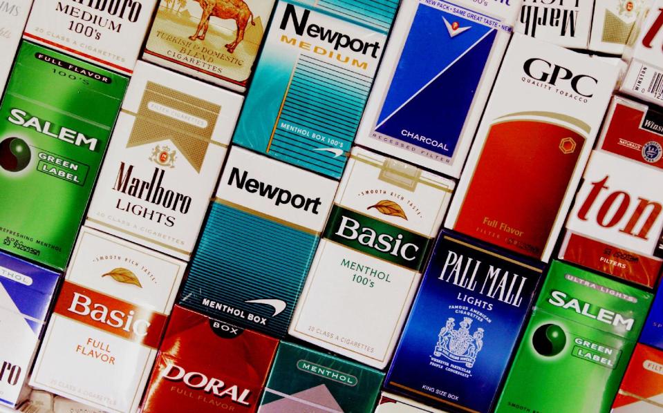 FILE - This Sept. 14, 2005 file photo shows packs of cigarettes in a store in Brunswick, Maine. It's no secret that smoking causes lung cancer. But what about diabetes, rheumatoid arthritis, erectile dysfunction? Fifty years into the war on smoking, scientists still are adding diseases to the long list of cigarettes' harms _ even as the government struggles to get more people to kick the habit. A new report from the U.S. Surgeon General's office says the nation is at a crossroads, celebrating decades of progress against the chief preventable killer but not yet poised to finish the job. (AP Photo/Pat Wellenbach, File)