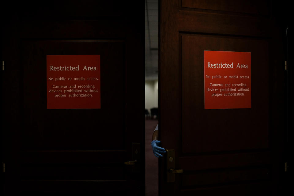 A custodial staff member walks into the sensitive compartmented information facility (SCIF), where Democrats conducted closed-door depositions during the House impeachment inquiry, in the basement of the Capitol in Washington, D.C., on Oct. 1, 2019. | Gabriella Demczuk for TIME