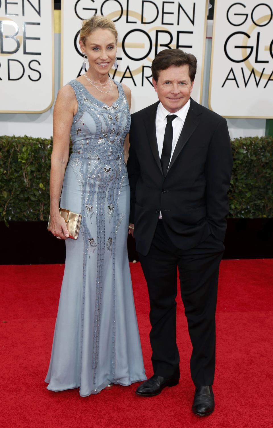 Actor Michael J. Fox and his wife Tracy Pollan arrive at the 71st annual Golden Globe Awards in Beverly Hills, California January 12, 2014. REUTERS/Danny Moloshok (UNITED STATES - Tags: Entertainment)(GOLDENGLOBES-ARRIVALS)