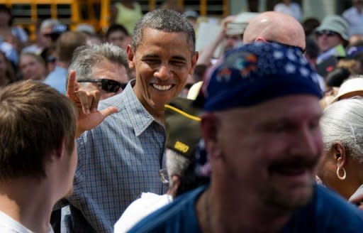 US President Barack Obama (C) greets people after speking during a campaign event at Wolcott House Museum Complex in Maumee, Ohio. Obama Thursday heralded his first re-election campaign bus tour with a new trade blast at China and fresh accusations his White House foe Mitt Romney helped send US jobs abroad