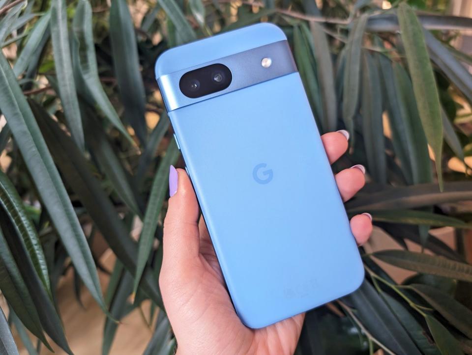 google pixel 8a held in hand with purple nails