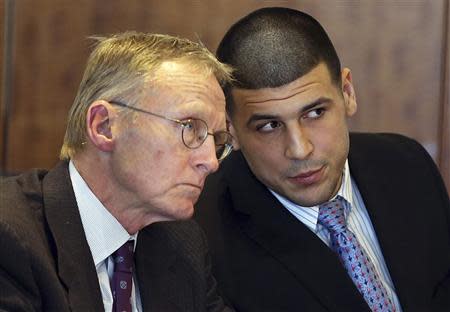 Aaron Hernandez (R) chats with his lawyer Charles Rankin as he appears for a pre-trial hearing at Bristol County Superior Court in Fall River, Massachusetts February 7, 2014. REUTERS/Jonathan Wiggs/Boston Globe/Pool
