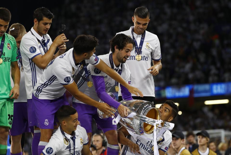 <p>Real Madrid’s Isco celebrates with the trophy after winning the UEFA Champions League Final </p>