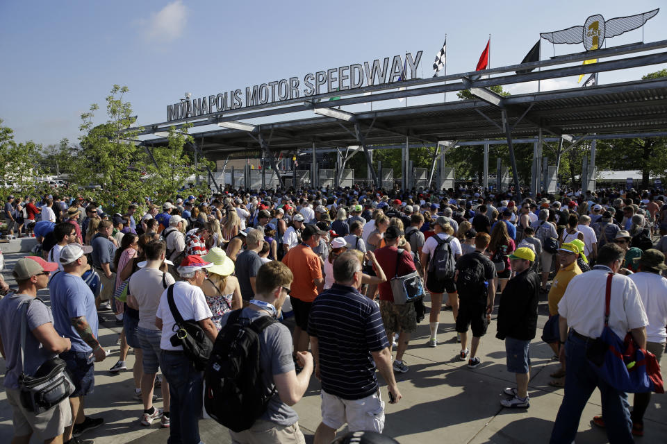 FILE - Fans make their way through the main gate and security as they arrive before the 100th running of the Indianapolis 500 auto race at Indianapolis Motor Speedway in Indianapolis, in this Sunday, May 29, 2016, file photo. The Indianapolis 500 will be the largest sporting event since the start of the pandemic with 135,000 spectators permitted to attend “The Greatest Spectacle in Racing” next month. Indianapolis Motor Speedway said Wednesday, April 21, 2021, it worked with the Marion County Public Health Department to determine 40% of venue capacity can attend the May 30 race. (AP Photo/Jeff Roberson, File)
