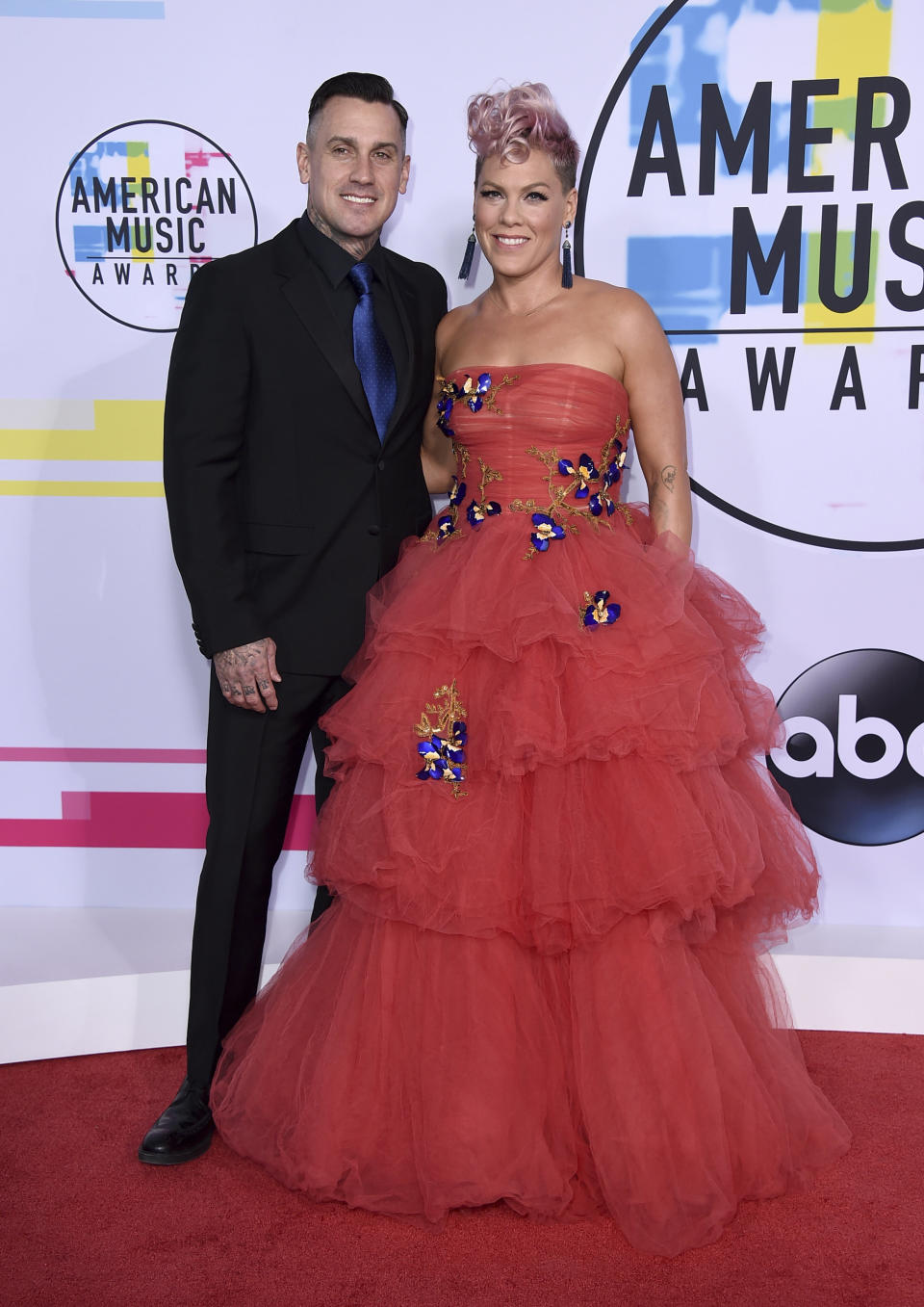 Carey Hart (left) and Pink arrive at the American Music Awards in November 2017 in Los Angeles. Pink spoke on "The Ellen DeGeneres Show" about the time she slashed Hart's tires. (Photo: Jordan Strauss/Invision/AP)