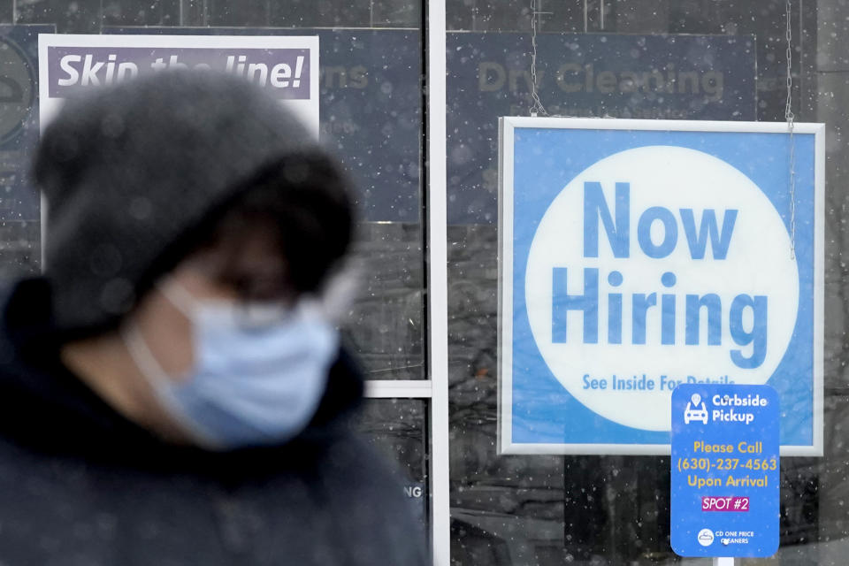 FILE - In this Saturday, Feb. 6, 2021 file photo, a now hiring sign is displayed at a CD One Price Cleaners in Schaumburg, Ill. The number of Americans applying for unemployment aid rose last week to 861,000, evidence that layoffs remain painfully high despite a steady drop in the number of confirmed viral infections. Applications from laid-off workers rose 13,000 from the previous week, which was revised sharply higher, the Labor Department said Thursday, Feb. 18. (AP Photo/Nam Y. Huh, File)