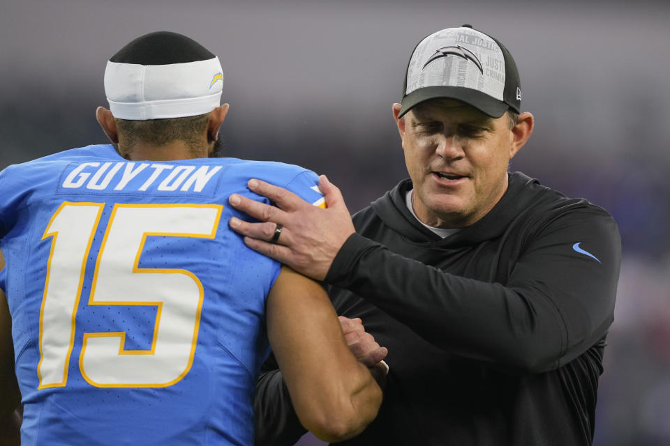 Los Angeles Chargers head coach Giff Smith shakes hands with wide receiver Jalen Guyton (15) before an NFL football game against the Buffalo Bills, Saturday, Dec. 23, 2023, in Inglewood, Calif. (AP Photo/Ryan Sun)
