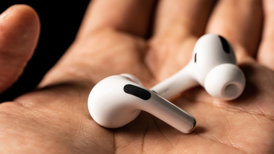 Apple AirPods Pro in someone's hand