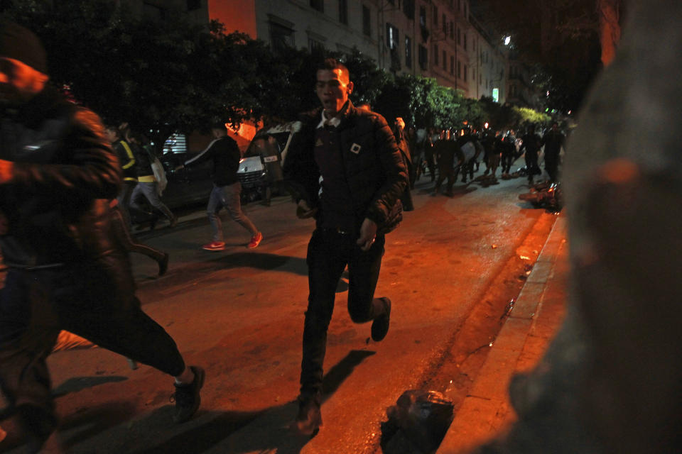 Riot police officers chase protesters after the presidential elections, Thursday Dec.12, 2019 in Algiers. Algerians — without a leader since April — voted for a new president or boycotted and held street protests against the elections decried by a massive pro-democracy movement that forced former leader Abdelaziz Bouteflika to resign. (AP Photo/Fateh Guidoum)