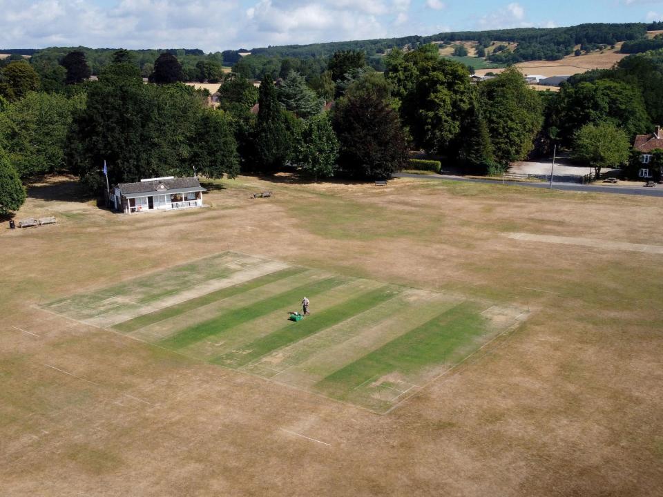 Vic Lilley, groundsman at Boughton and Eastwell Cricket Club in Ashford, Kent, prepares the wickets for matches this weekend (PA)