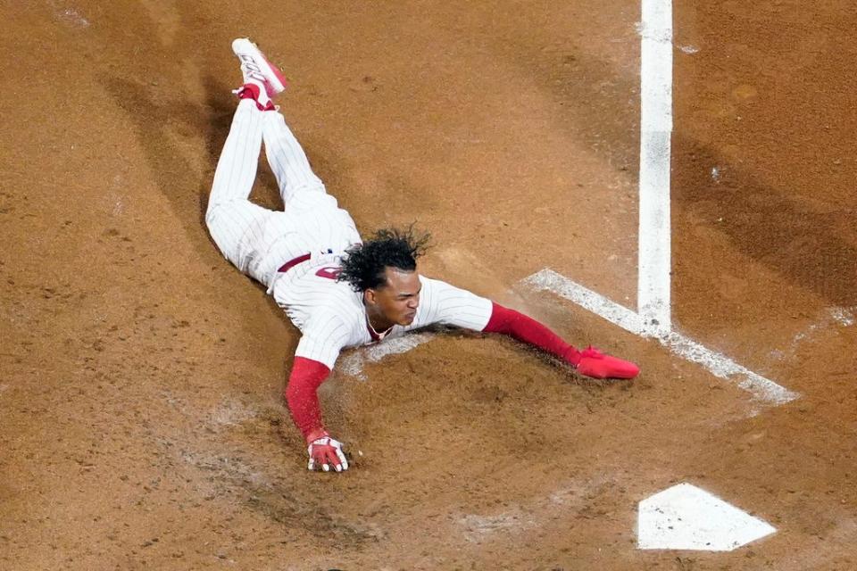 Philadelphia Phillies' Cristian Pache scores on a double by Kyle Schwarber during the third inning of Game 2 in an NL wild-card baseball playoff series against the Miami Marlins, Wednesday, Oct. 4, 2023, in Philadelphia. (AP Photo/Matt Slocum)