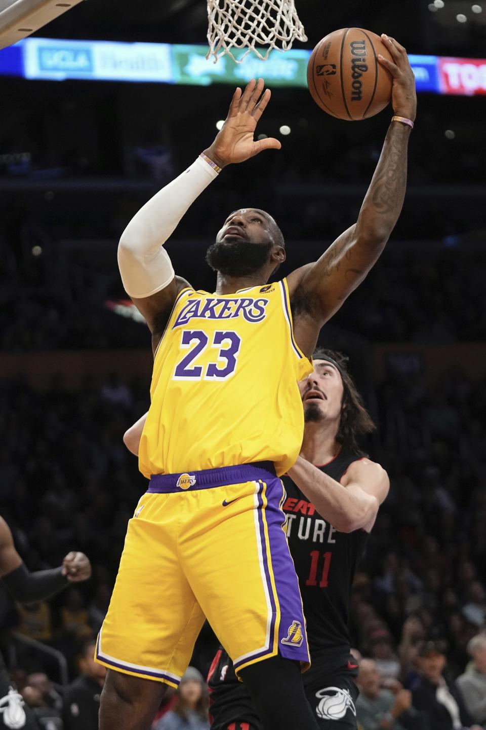 Los Angeles Lakers forward LeBron James, left, shoots as Miami Heat guard Jaime Jaquez Jr. defends during the first half of an NBA basketball game Wednesday, Jan. 3, 2024, in Los Angeles. (AP Photo/Mark J. Terrill)