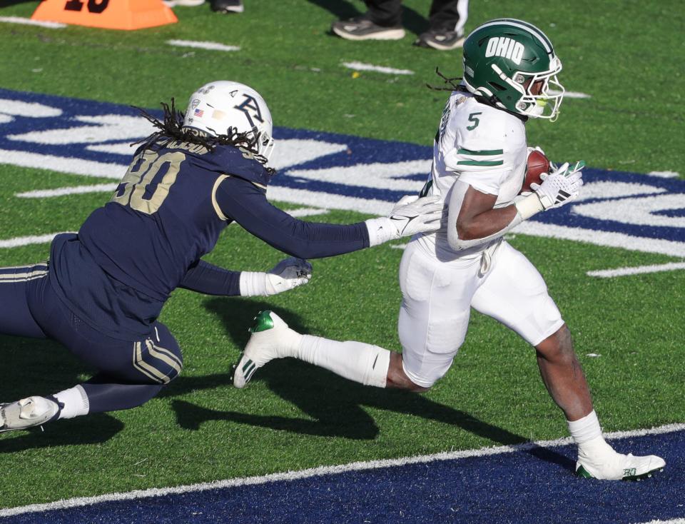 Ohio running back Sieh Bangura outraces Akron defender LaJoshua Jackson for a third-quarter touchdown on Friday, Nov. 24, 2023.
